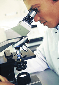 Photo of researcher looking in microscope